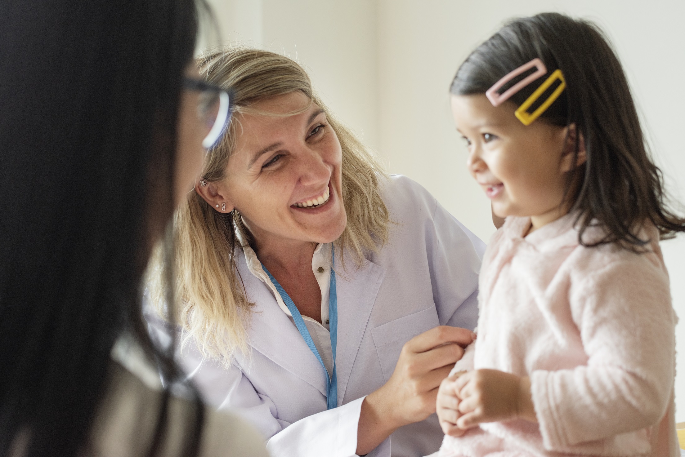 Pediatrician examining a little girl
